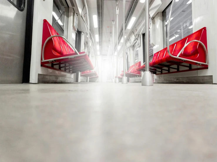 a couple of red benches sitting next to each other, inside of a metro train, white concrete floor, amanda lilleston, unblur