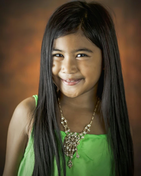 a young girl with long black hair wearing a green dress, by reyna rochin, shutterstock contest winner, headshot photo, joy ang, a girl with blonde hair, she has olive brown skin