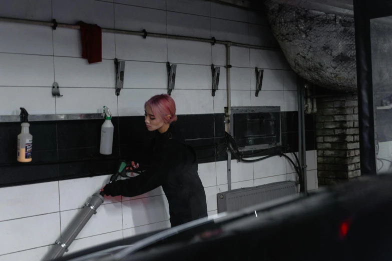 a woman is cleaning a car in a garage, inspired by Elsa Bleda, restaurant, square, high quality picture, kek