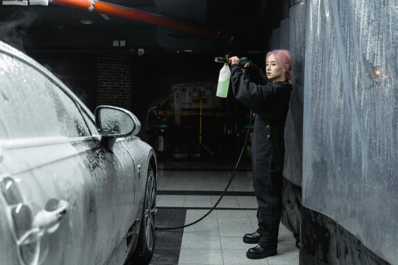 a man washing a car in a garage, by An Gyeon, pexels contest winner, auto-destructive art, cosplay on black harley queen, cai xukun, non-binary, kirsi salonen