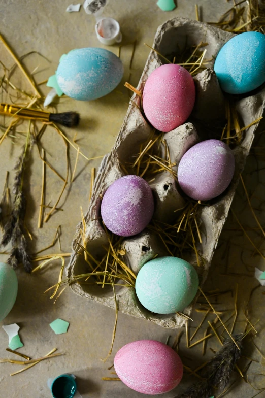 a carton filled with eggs sitting on top of a table, decorations, chalked, digging, deep pastel colours