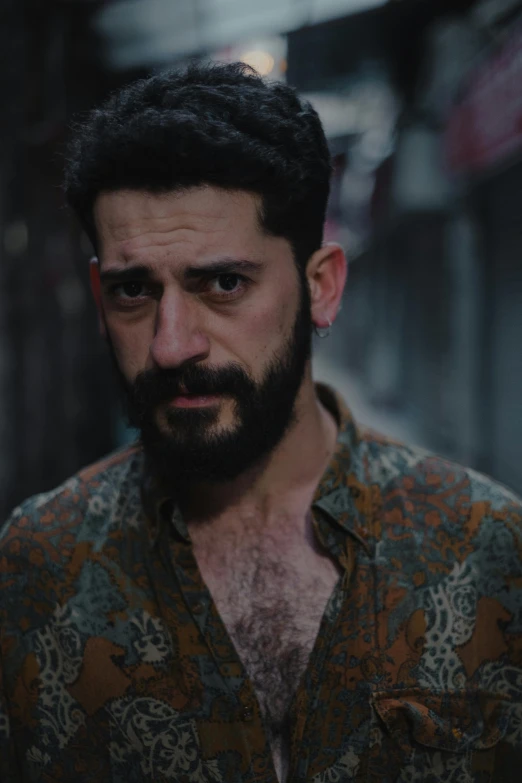 a man with a beard standing in a dark alley, an album cover, by Elsa Bleda, screenshot from a movie, looking smug, sayem reza, ( ( theatrical ) )