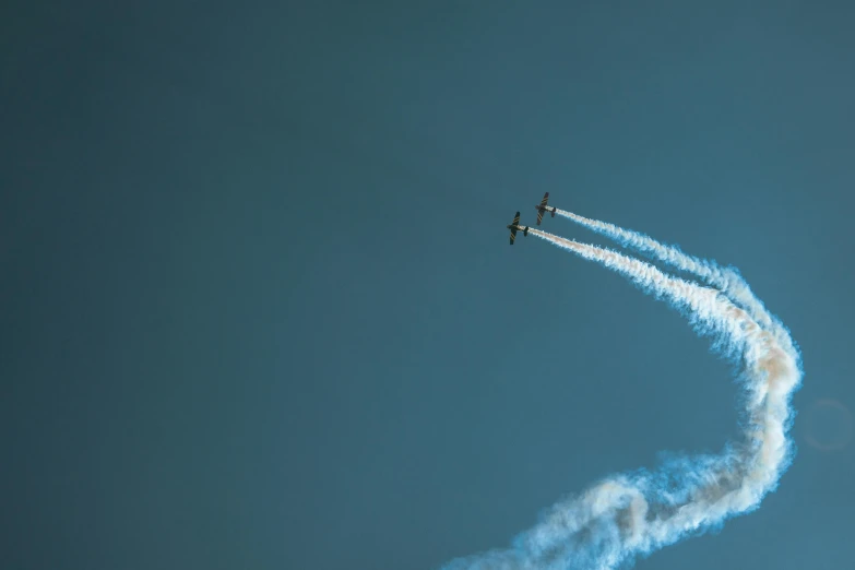 a couple of airplanes flying through a blue sky, a picture, pexels contest winner, precisionism, smokey cannons, thumbnail, festivals, telephoto shot