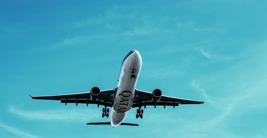 a large jetliner flying through a blue sky, pexels contest winner, avatar image, landing gear, thumbnail, mecca