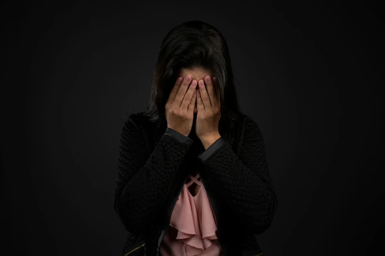 a woman covers her face with her hands, by Eglon van der Neer, pexels, hurufiyya, dark backdrop, blind, woman crying, woman with black hair