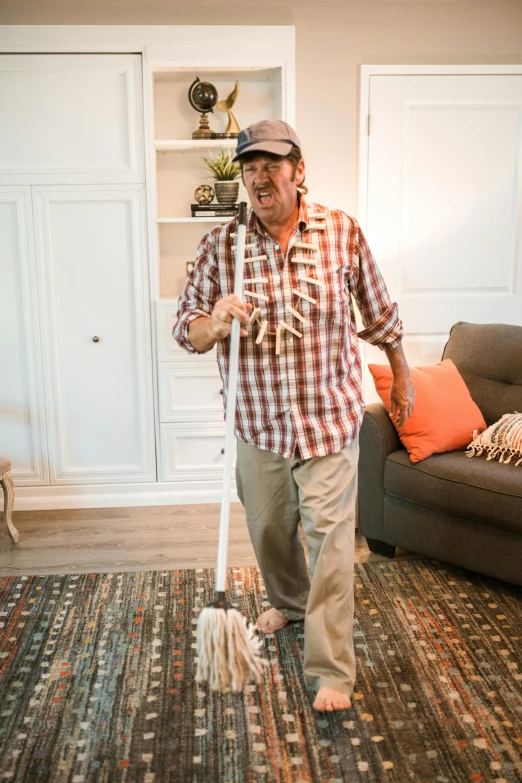 a man mopping a living room floor with a mop, a portrait, by Ben Zoeller, reddit, dressed as a scavenger, promo image, joanna gaines, 15081959 21121991 01012000 4k