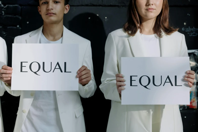 a group of people standing next to each other holding signs, trending on unsplash, bauhaus, equations, white uniform, bisexual lighting, background image