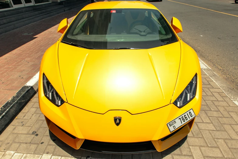 a yellow sports car parked on the side of the road, inspired by Bernardo Cavallino, pexels contest winner, renaissance, gta : dubai, front of car angle, super high resolution, symmetric!!