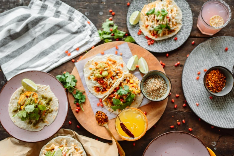 a wooden table topped with plates of food, by Carey Morris, pexels contest winner, hurufiyya, tacos, 🦩🪐🐞👩🏻🦳, sparkling, background image