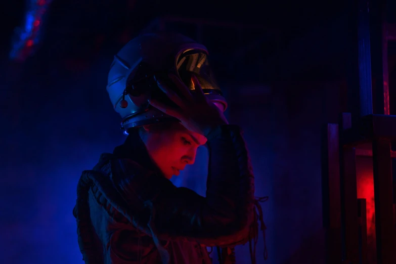 a person wearing a helmet in a dark room, inspired by Elsa Bleda, afrofuturism, in a crashed spaceship, ellen ripley, instagram post, cinematic outfit photo