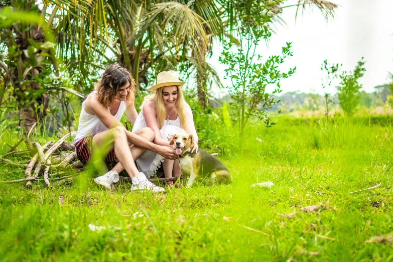 two women sitting in the grass with a dog, by Julia Pishtar, pexels, tropical style, avatar image, australian, happy couple