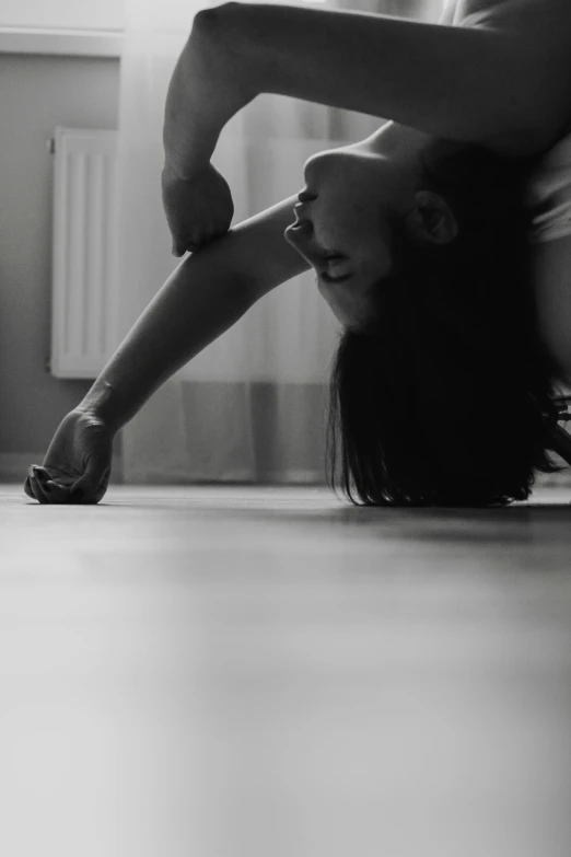 a black and white photo of a woman doing a handstand, by Adam Marczyński, sitting on the floor, “ sensual, music video, anime pose