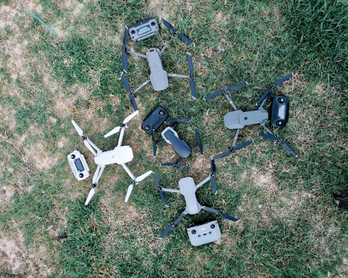 a group of drones sitting on top of a grass covered field, by Carey Morris, flatlay, gray, 6 colors, hardware