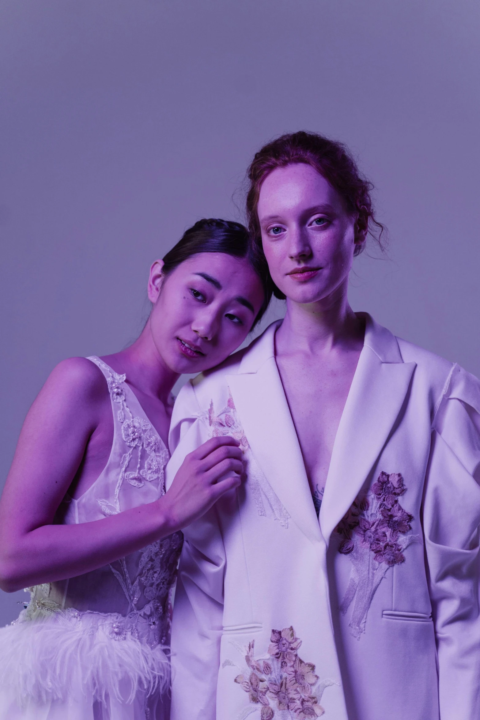 a couple of women standing next to each other, a portrait, inspired by Wang Duo, unsplash, white and purple, fashion studio lighting, very pale, fiona staples and kinu nishimura