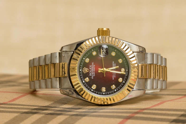 a close up of a watch on a table, a portrait, pexels contest winner, red and gold, rolex, hyperrealistic shaded, 🦩🪐🐞👩🏻🦳