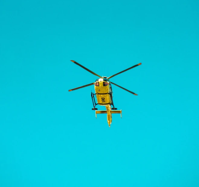 a yellow helicopter flying through a blue sky, pexels contest winner, medical, hq 4k phone wallpaper, on simple background, instagram post