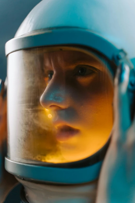 a close up of a person wearing a helmet, by Adam Marczyński, girl looks at the space, biopic, **cinematic, brightly lit