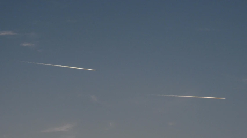 a couple of airplanes flying through a blue sky, by Niko Henrichon, minimalism, meteor, morning detail, medium long shot, minimalissimo