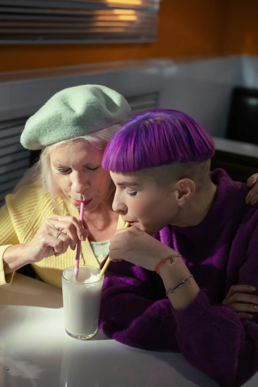 a group of people sitting around a table drinking milk, a colorized photo, trending on pexels, pop art, she has purple hair, lesbian embrace, wearing a beret, older woman