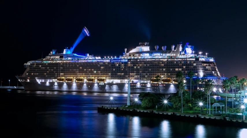 a cruise ship docked in a harbor at night, pexels contest winner, avatar image, blue and yellow lighting, royal photo, sport