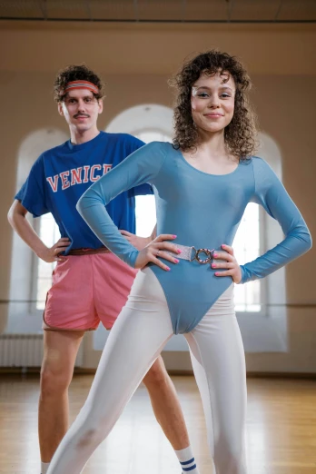 a man and a woman posing for a picture in a dance studio, an album cover, inspired by Graham Forsythe, renaissance, wearing track and field suit, rebecca sugar, 1990 photograph, wearing leotard