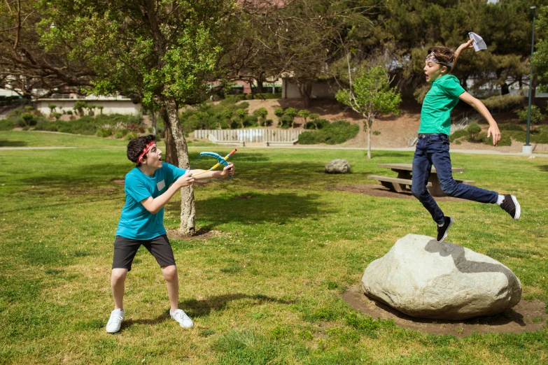 a man and a boy playing frisbee in a park, shutterstock contest winner, happening, holding a trident, prop rocks, basil flying, photoshopped