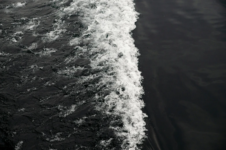 a man riding a surfboard on top of a wave, a stipple, inspired by Andreas Gursky, pexels contest winner, process art, river running through it, white on black, on a yacht at sea, abstract detail