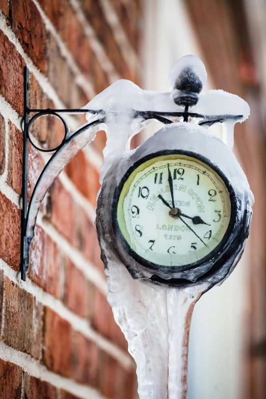 a clock hanging on the side of a brick building, a photo, inspired by Arthur Burdett Frost, trending on pexels, wearing ice crystals, scorching weather, a quaint, ilustration