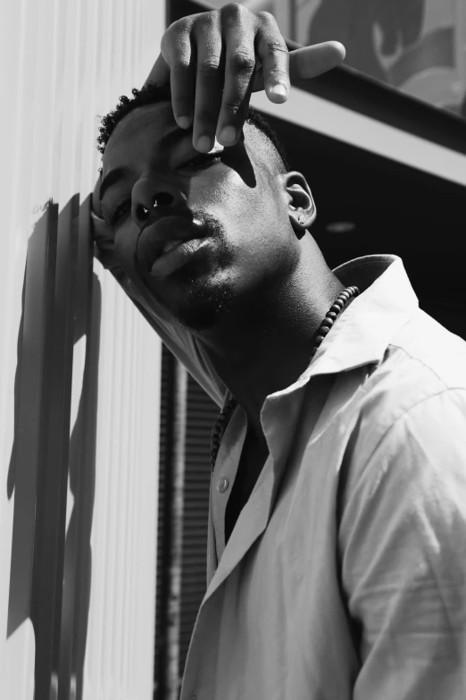a black and white photo of a man smoking a cigarette, a black and white photo, by Charles Martin, trending on pexels, playboi carti, low sun, an all white human, ox