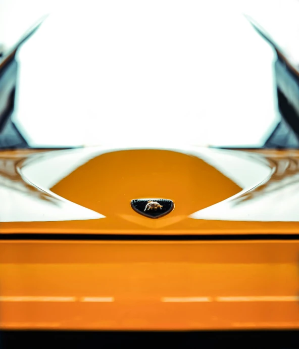 a close up of a yellow sports car, a macro photograph, by Matthias Weischer, unsplash, white and orange breastplate, symmetry feature, lotus, high quality photo