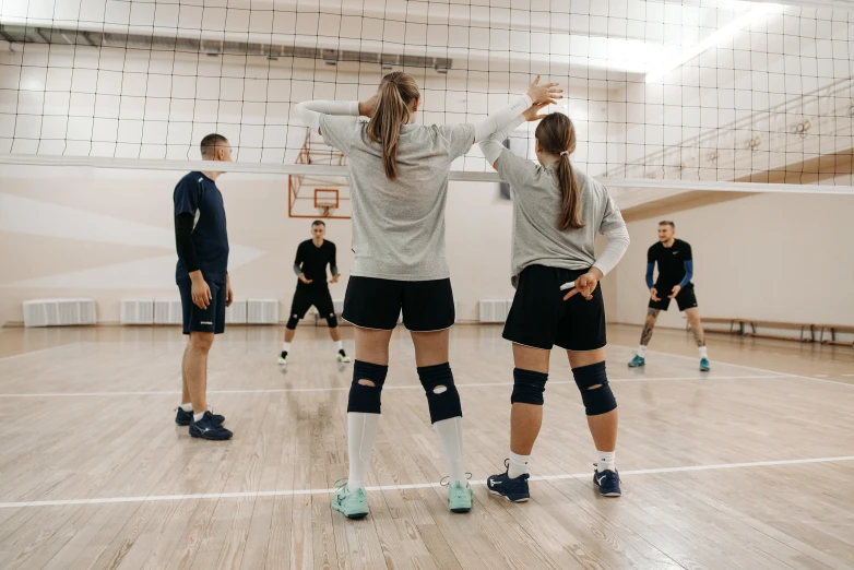 a group of people playing a game of volleyball, trending on pexels, american barbizon school, full body full height, anastasia ovchinnikova, profile image, back to back