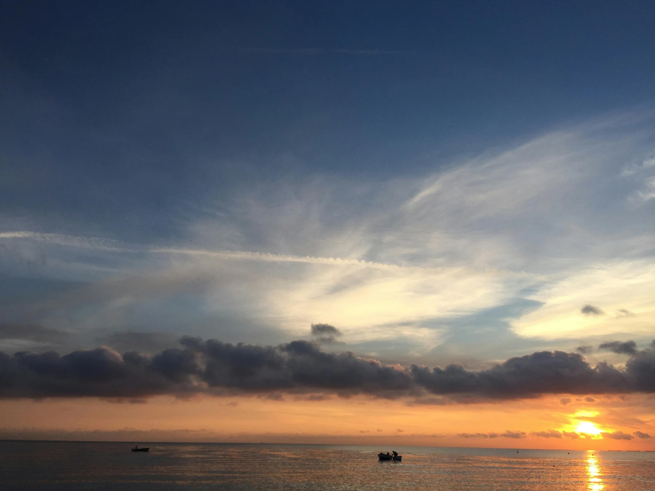 a couple of boats floating on top of a body of water, pexels contest winner, romanticism, sunset clouds, gulf of naples, # nofilter, high-resolution photo