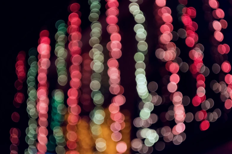 a close up of a street light with blurry lights, by Carey Morris, generative art, colorful dots, holiday season, soft pink lights, multicolor