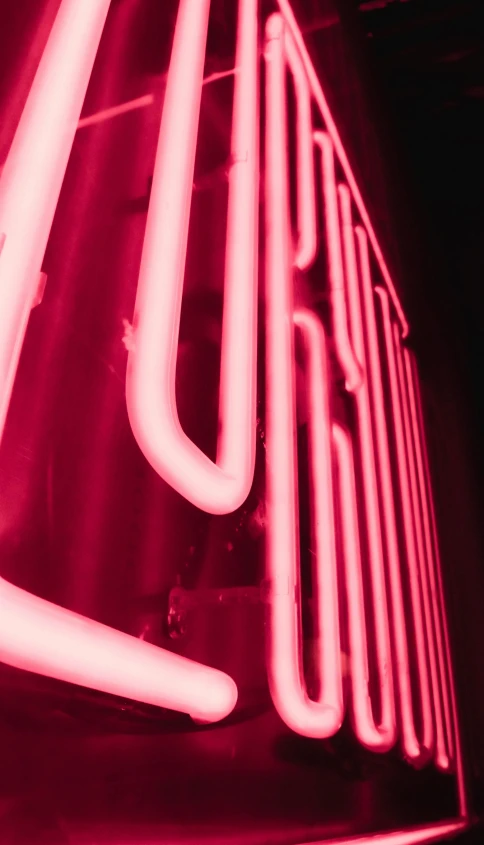 a neon sign hanging from the side of a building, unsplash, ((pink)), dynamic closeup, reds, elliot alderson