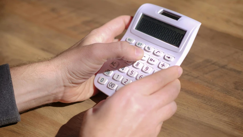 a person using a calculator on a wooden table, 15081959 21121991 01012000 4k, lachlan bailey, modeled, thumbnail