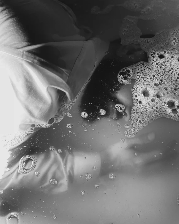 a black and white photo of a woman in a bathtub, process art, lots of bubbles, morning detail, wet fabric, g cgsociety