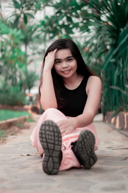 a woman sitting on the ground posing for a picture, by Bernardino Mei, pexels contest winner, realism, young cute wan asian face, lush surroundings, teenage, full frame image