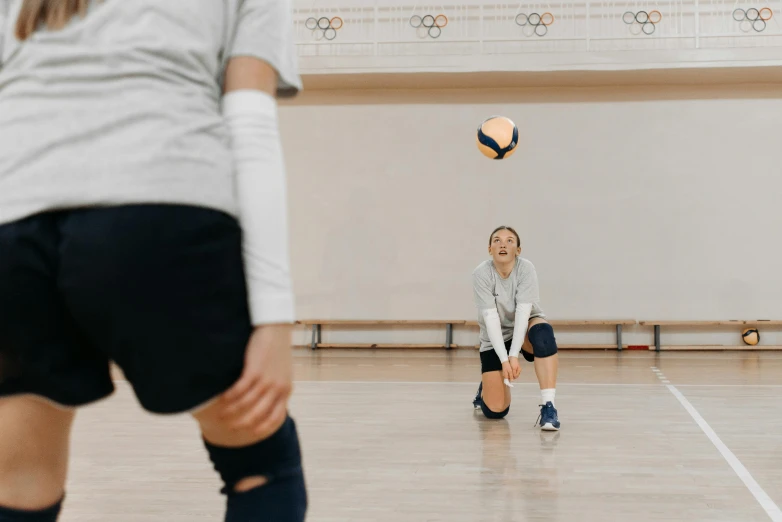 a group of young women playing a game of volleyball, unsplash contest winner, shin hanga, wearing knee and elbow pads, profile image, indoor picture, lachlan bailey