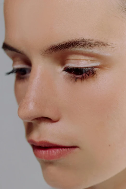 a close up of a woman with short hair, ivory make up, soft shadow transition, face partially obscured, natural make-up