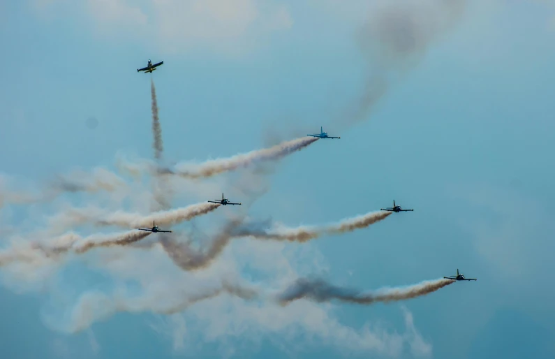 a group of airplanes flying through a blue sky, a portrait, pexels contest winner, figuration libre, smokey cannons, concert, panels, thunderbirds