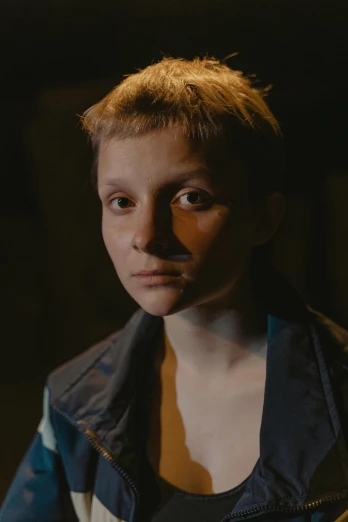 a close up of a person wearing a jacket, by Adam Marczyński, greta thunberg, with cinematic lighting, light over boy, ( ( theatrical ) )