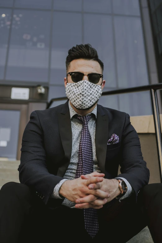 a man in a suit and tie wearing a mask, reddit, sitting down casually, looking heckin cool and stylish, instagram photo, patterned