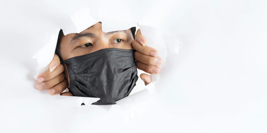 a man looking through a hole in a sheet of paper, trending on pexels, plasticien, black facemask, asian male, on a white background, made of lab tissue