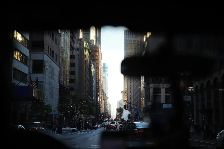 a city street filled with lots of traffic and tall buildings, inspired by Thomas Struth, pexels contest winner, looking through a window frame, first-person view, inside of a car, in new york