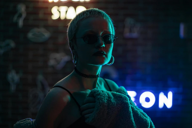 a woman standing in front of a neon sign, inspired by Elsa Bleda, trending on pexels, neo-figurative, girl with short white hair, neo - noir setting, girl wearing round glasses, reflecting light in a nightclub