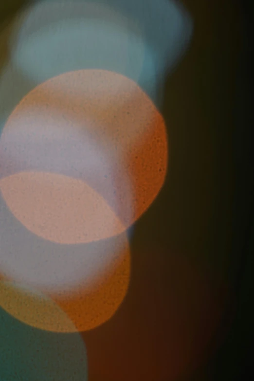 a blurry image of a traffic light, a picture, by Jan Rustem, lyrical abstraction, translucent orbs, orange light, soft geometry, 1960s color photograph