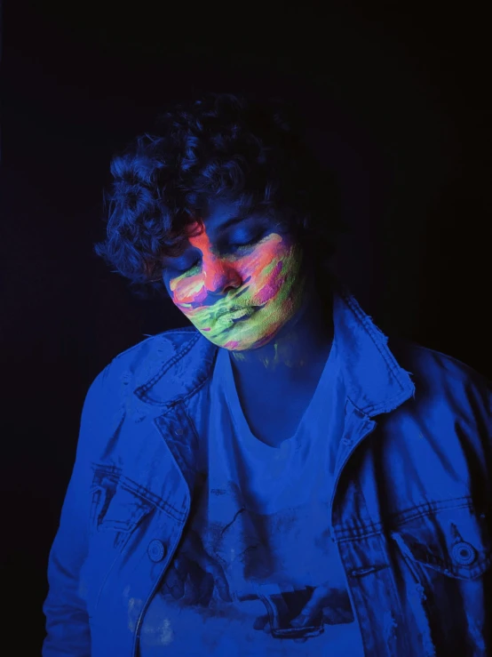 a man with black light on his face, an album cover, inspired by Elsa Bleda, pexels, joe keery, colored paint, andy milonakis, snapchat photo