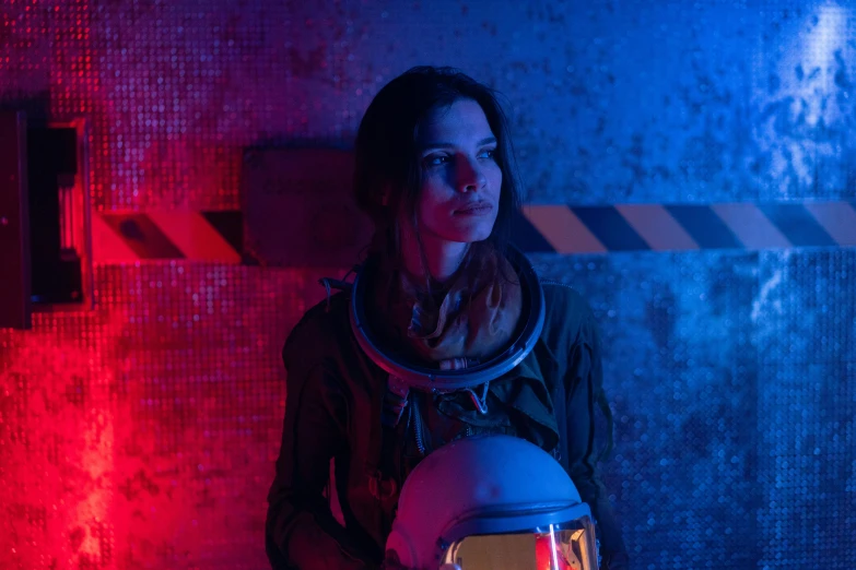 a woman in a space suit holding a helmet, pexels contest winner, serial art, film still from horror movie, action shot girl in parka, sci-fi night club, h3h3