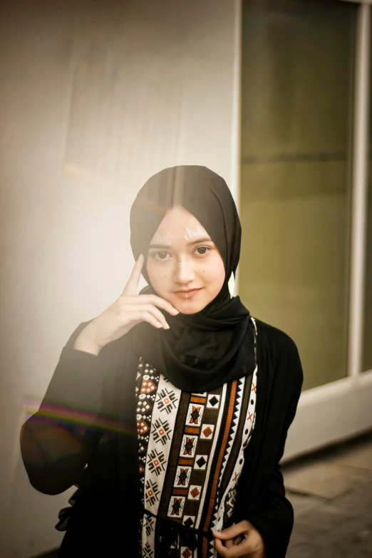 a woman in a hijab poses for a picture, pexels contest winner, girl with black hair, black and brown, at college, ((portrait))