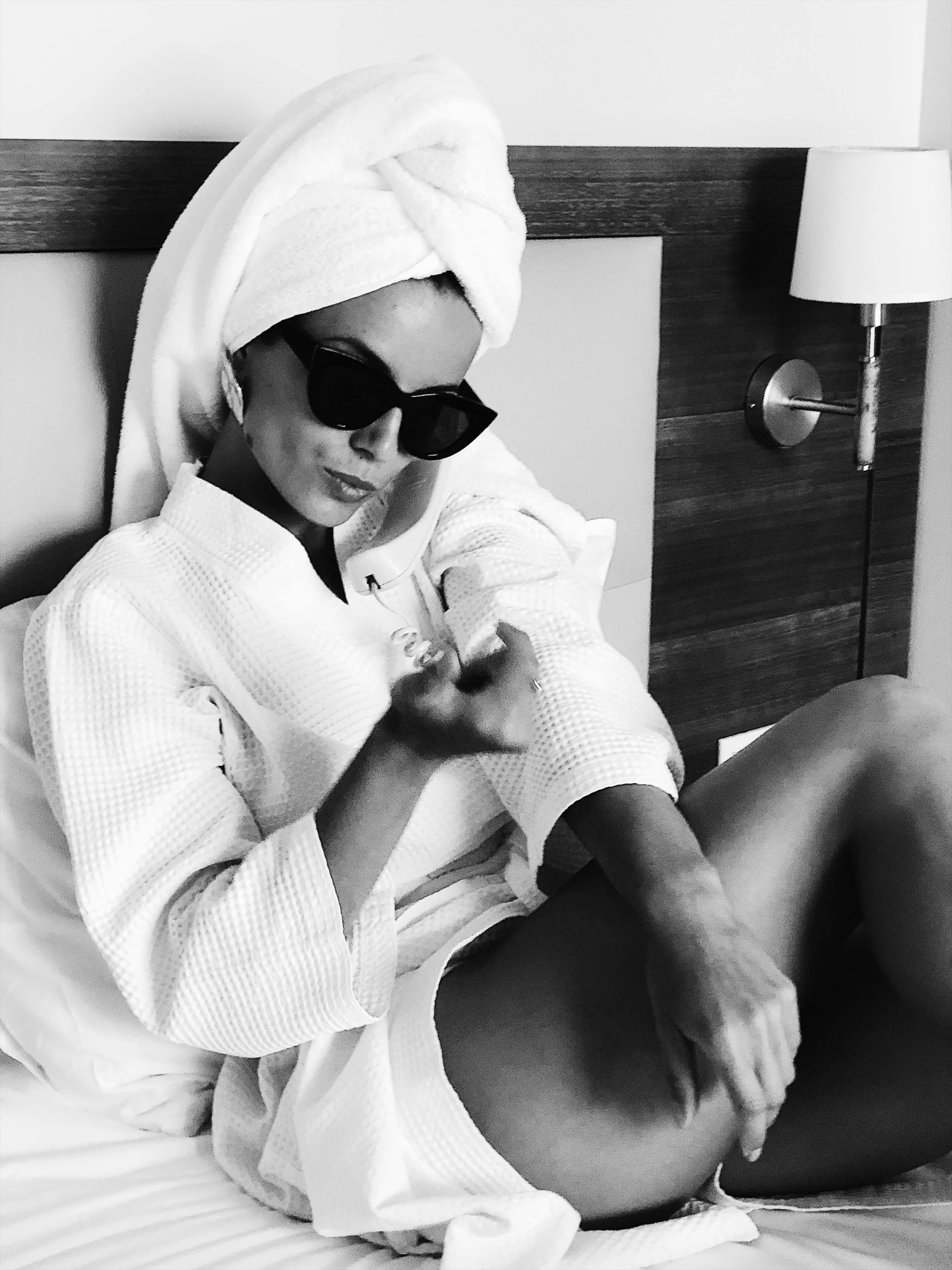 a black and white photo of a woman in a bathrobe, inspired by Helmut Newton, trending on instagram, kate beckinsale weared as thief, wearing versace sunglasses, wearing a white bathing cap, thighs!!!